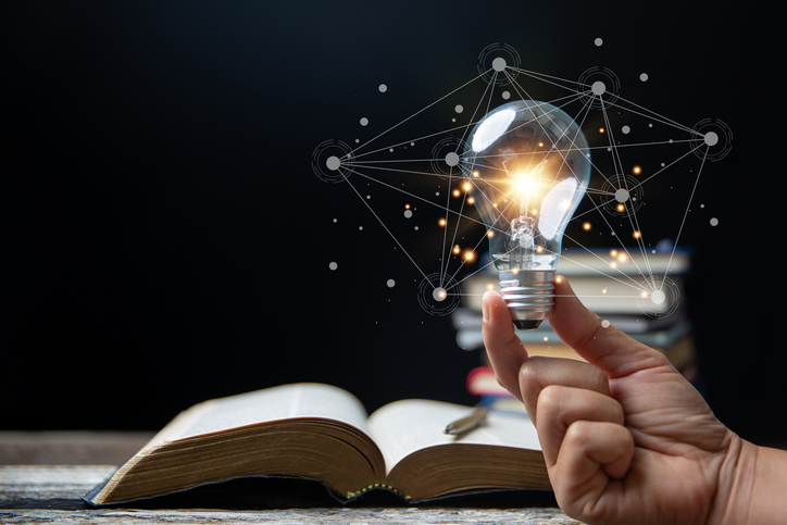 Light bulbs and books. Concept of reading books, knowledge, and searching for new ideas. Innovation and inspiration, Creativity with twinkling lights, the inspiration of ideas.